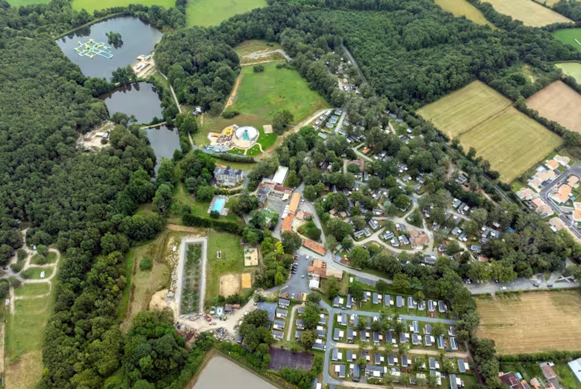 Aerial view of Château La Forêt campsite in the Vendée – spacious family-friendly campsite with swimming pools, adventure park, and scenic woodland surroundings