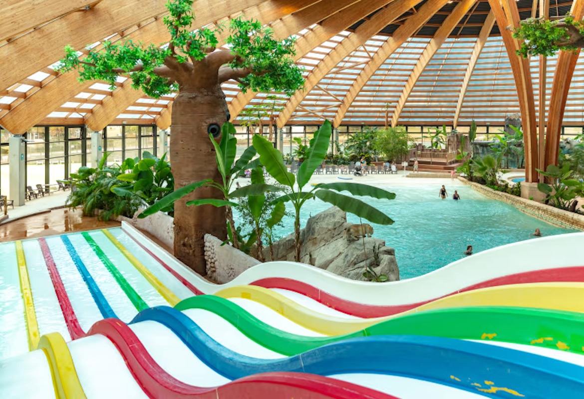 Domaine des Ormes indoor pool area with multi lane slides