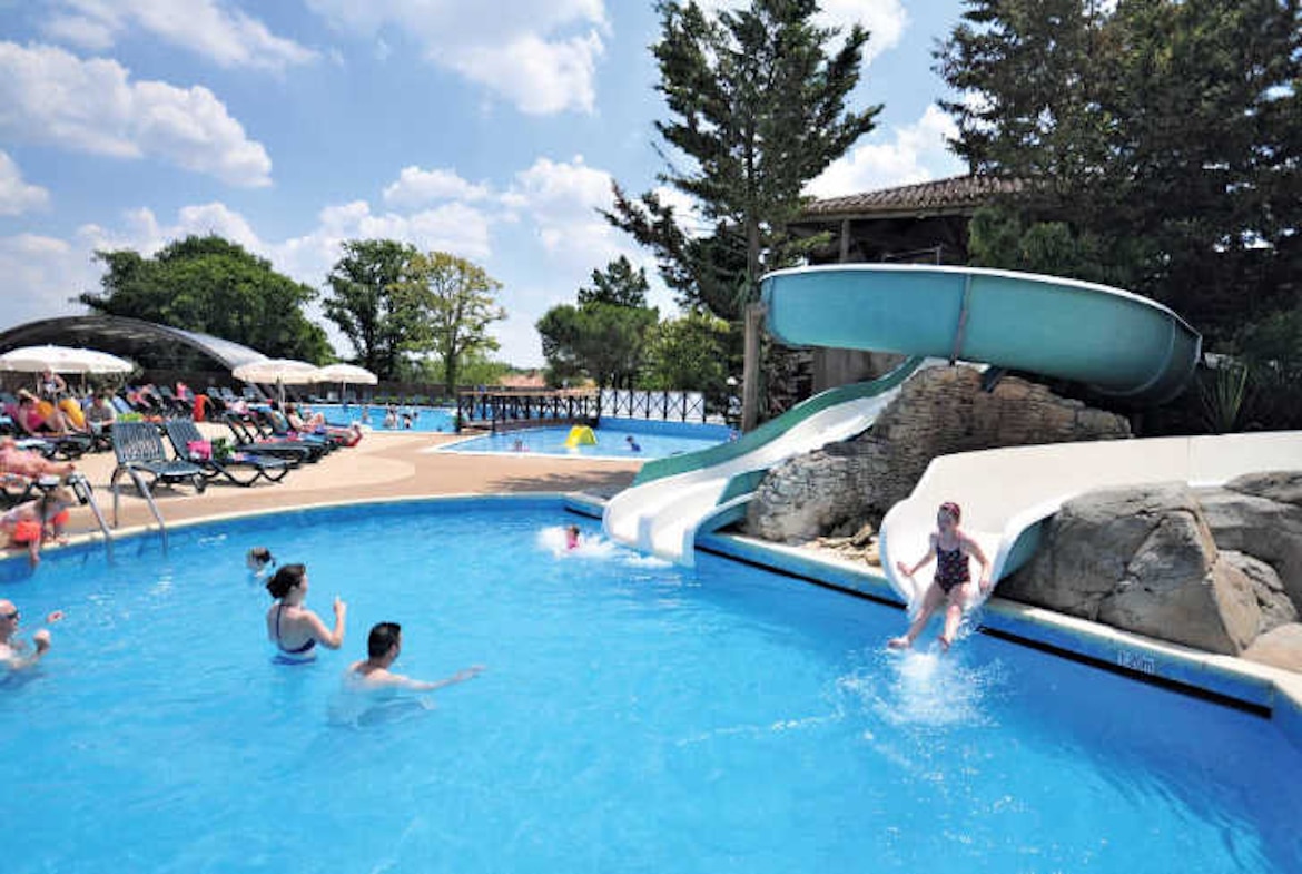 Kids enjoying the twisty slides at Camping La Garangeoire’s water park in the Vendée